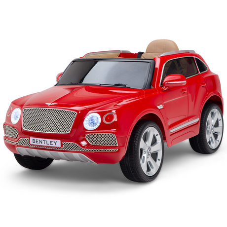 The Red 12V Bentley Bentayga Kids Licensed 1-Seater Ride-On Car perfectly resembles a Bentley SUV, with detailed headlights, front grille, silver wheels, a beige interior, and a comfy leather seat.