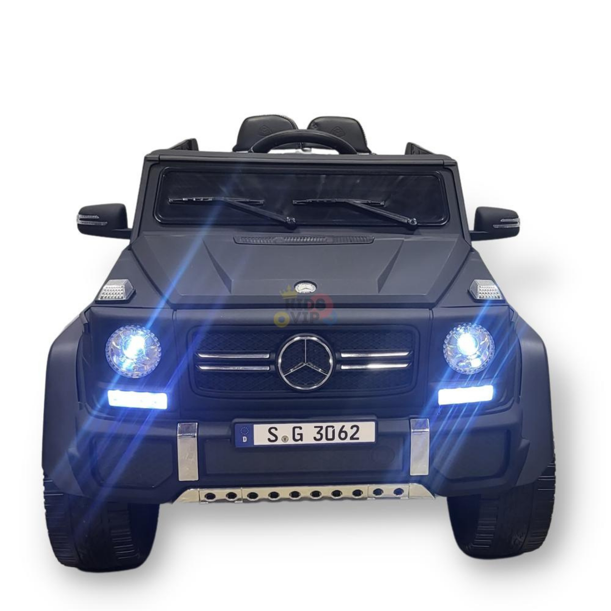 A matte black 12V Mercedes Benz Maybach G650s kids ride-on car features 4X4 rubber wheels, glowing headlights, a prominent front grille, visible seats, and a small license plate S G 3062, set against a plain white background. Includes a remote for added control.