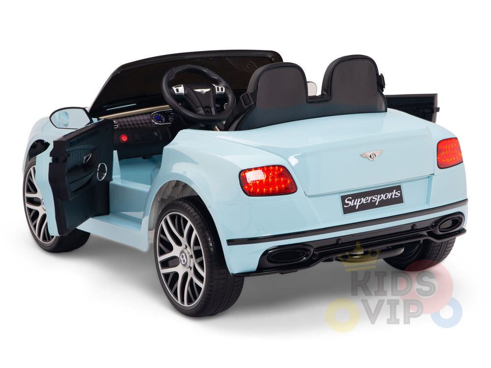 The Blue 12V Bentley GTC Kids Licensed Ride On Car features rubber wheels and a remote. It boasts leather black seats, opening doors, a Supersports label on the back, detailed headlights, taillights, and an interior with a dashboard and steering wheel.