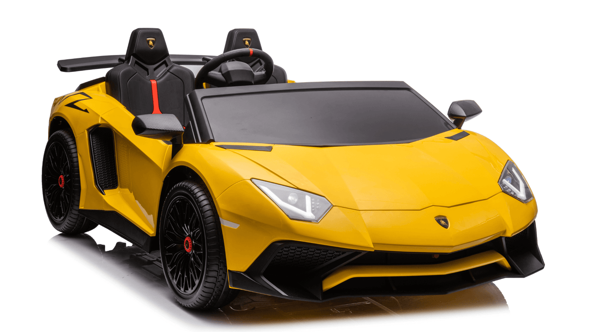 Yellow 24V/180W Lamborghini SV Limited XXL Edition ride-on toy with eco-leather seats, black details, and a steering wheel. It features two seats, sleek lines, sharp angles of a true sports car, and runs on a brushless motor for driving fun at speeds up to 10MPH!.