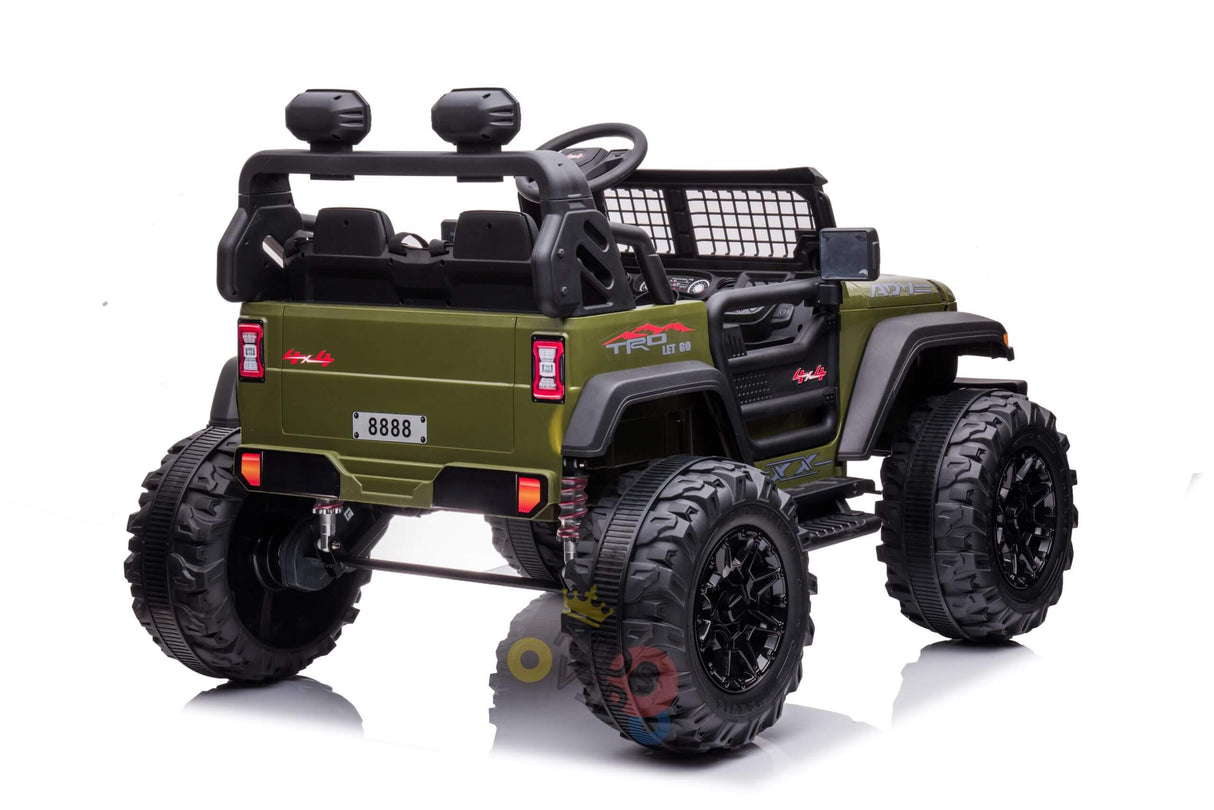 The Green 24V/4WD Xtreme Ride on Truck features large black Eva Wheels, leather seats, a roll cage, side mirrors, and a netted rear window, shown from the rear angle against a white background.