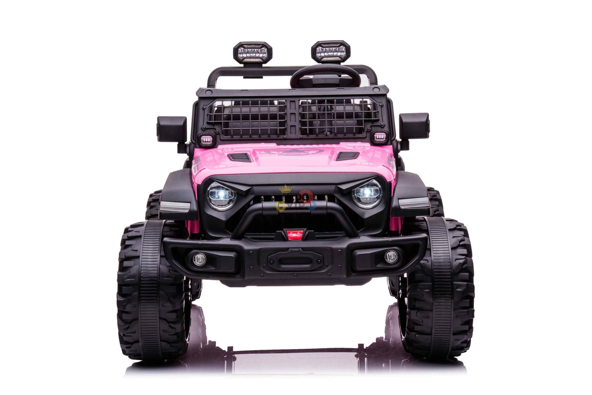 The Pink 24V/4WD Xtreme Ride on Truck, complete with Eva wheels and leather seats, showcases large black tires, a front grille, roof-mounted spotlights, and a sturdy bumper. Designed for kids play with rugged charm and safety features like a parental remote control. The jeep faces forward against a white backdrop.