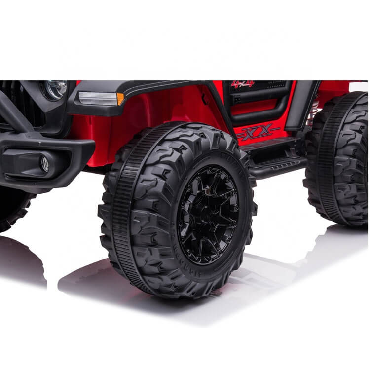 Close-up of a red 24V/4WD Xtreme Ride on Truck, featuring rugged Eva Wheels with deep treads and intricate rims, sporty decals, and leather seats.