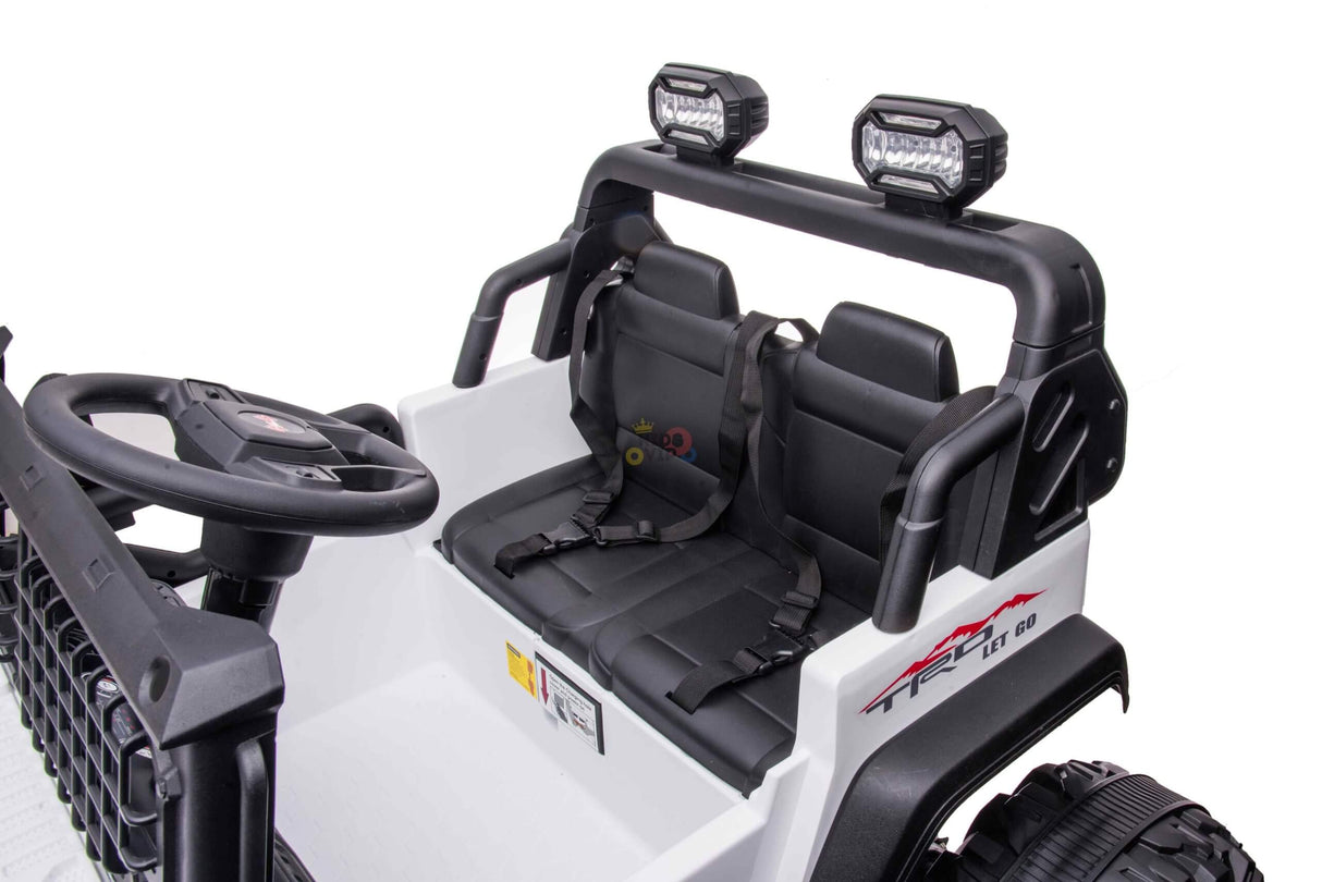 The White 24V/4WD Xtreme Ride on Truck features black accents, EVA wheels, two black leather seats with seat belts, a steering wheel, a dashboard, and overhead lights for an adventurous ride.