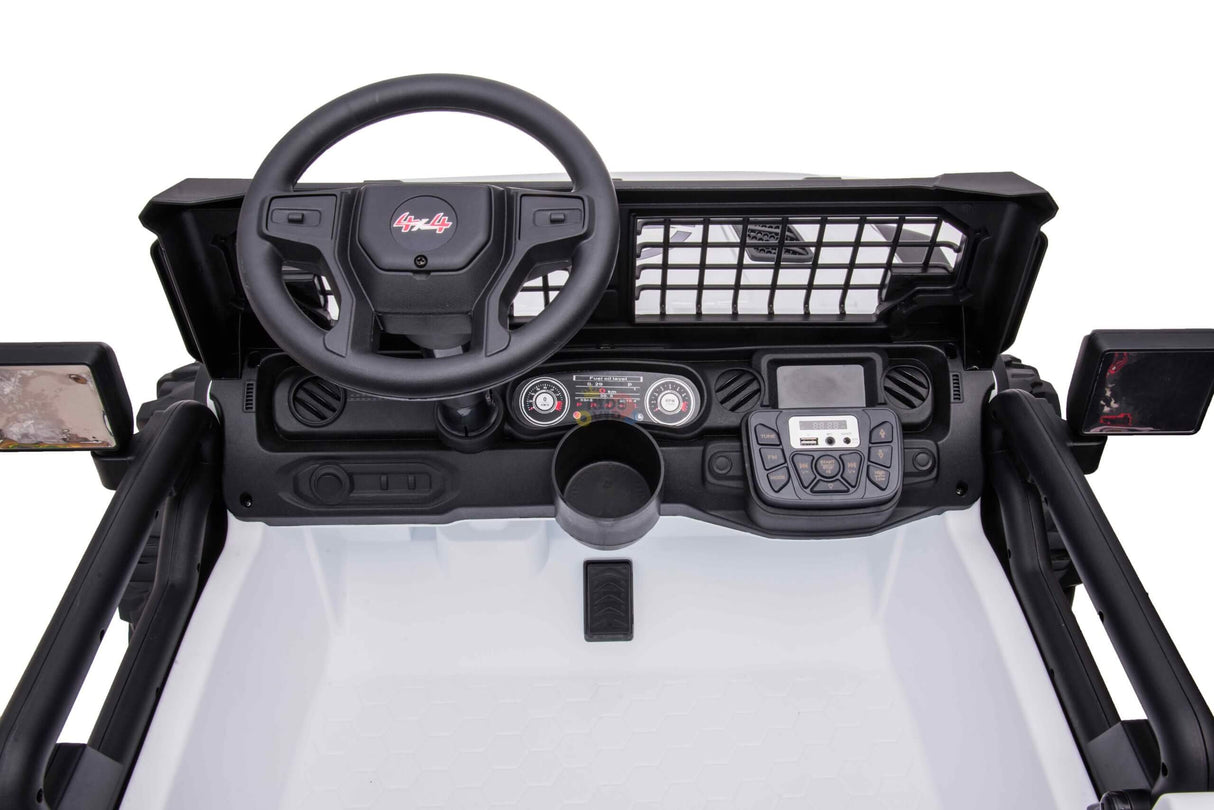 Interior view of the White 24V/4WD Xtreme Ride on Truck dashboard with steering wheel, control buttons, central display, netted panel, dual side mirrors, and a small storage compartment. The 2-seater truck features black and white design with metallic accents. Eva wheels and leather seats included.