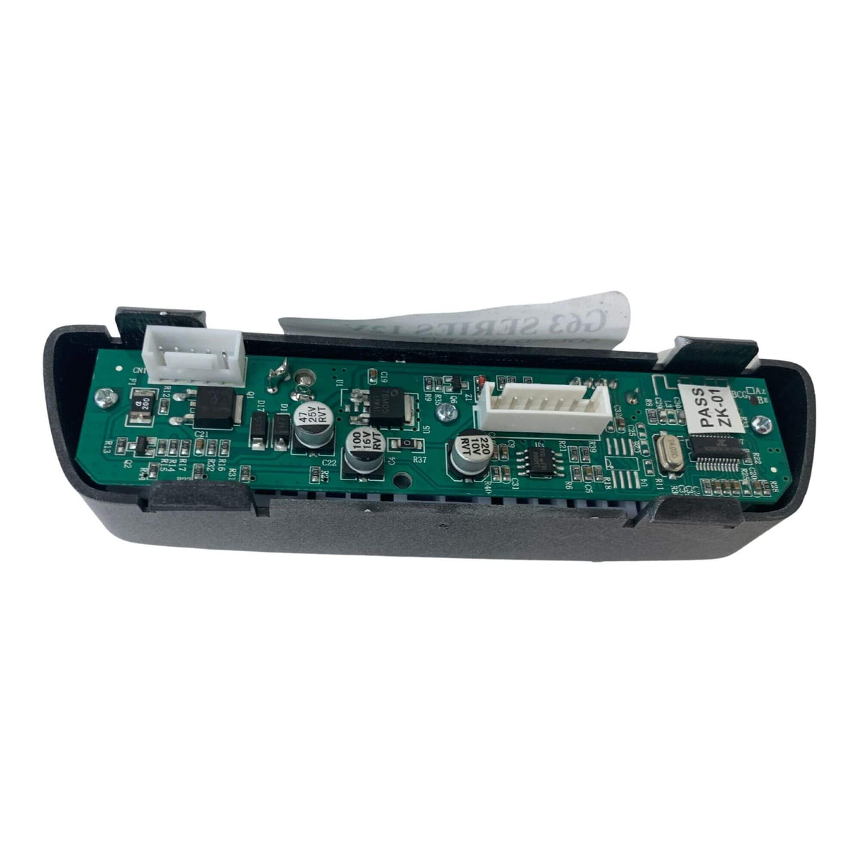 A close-up of an electronic circuit board featuring capacitors, connectors, and small chips in a black plastic casing. A paper tag extends from the top, similar to those in premium ride-on car models like the 12V Mercedes-Benz G63 – Soundboard at kidsviponline.