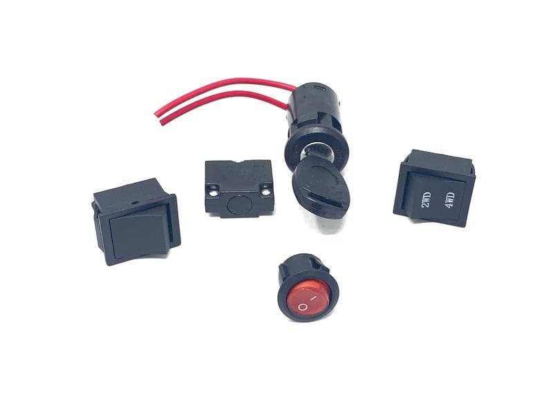 Upgrade your Ride-On Car with our Enhance Your UTV Sport Edition 12v switch set. It features a toggle switch with red wires, rocker switches for ON and OFF, plus a red push button and small rectangular button, perfect replacements for the Sport Edition model.