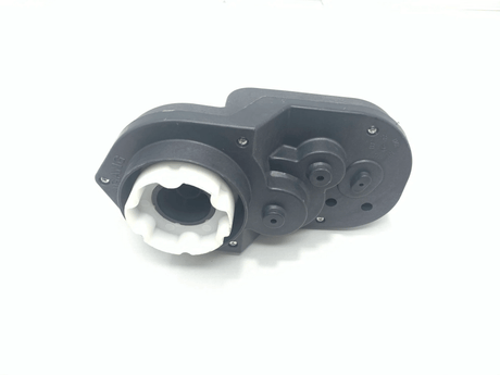 Close-up of a black mechanical component, Enhance Your 12v Discovery with a High-Quality Left Gear Box, featuring a white circular gear-like part. It includes circular and rectangular shapes, screws, and intricate details on its surface against a plain white background.