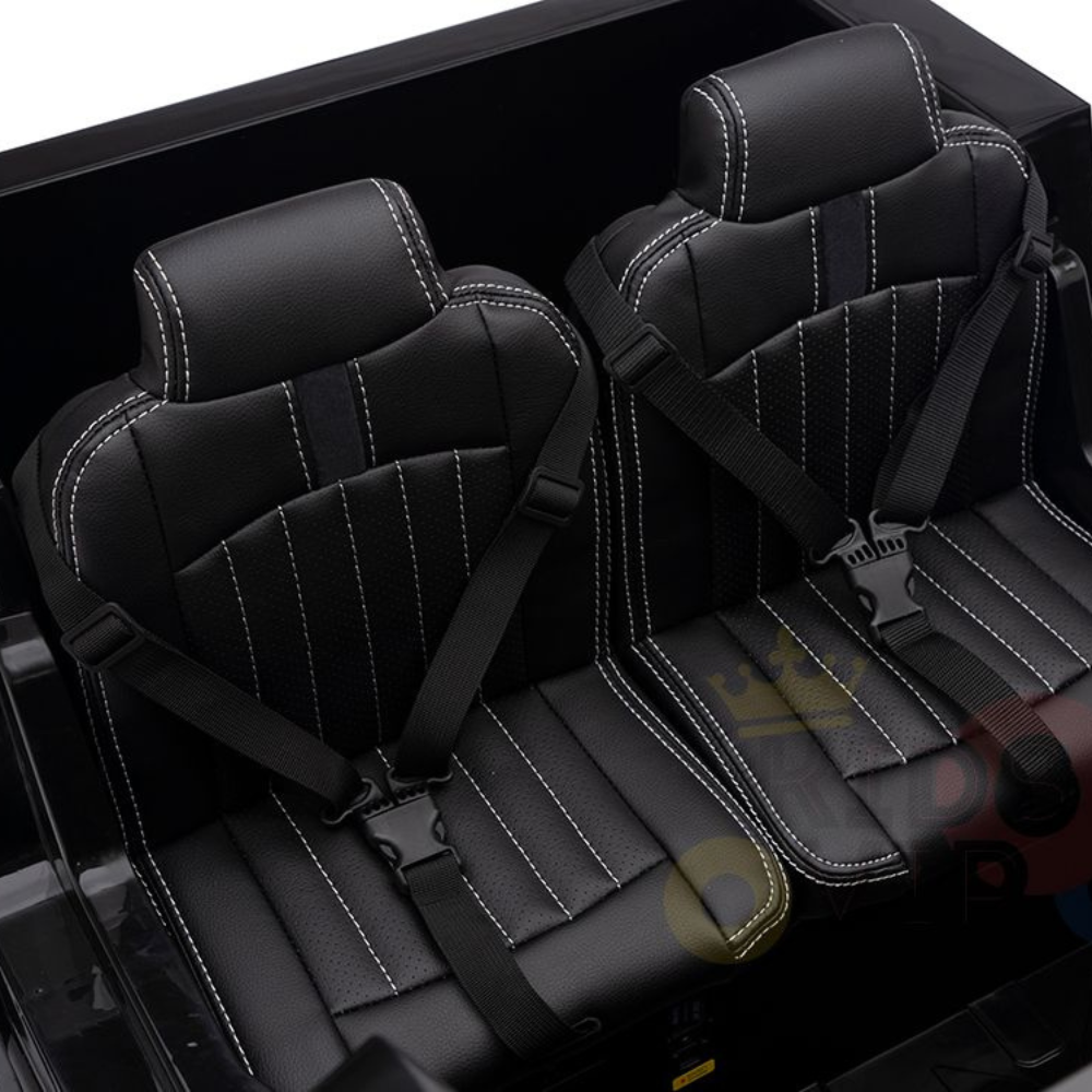 These textured black car seats with white stitching and seat belts offer a sporty high-back design. Tailored for the Black 24V XXL Mercedes Benz Zetros Kids Ride On Truck, they provide distinct seating areas for adventurous rides.