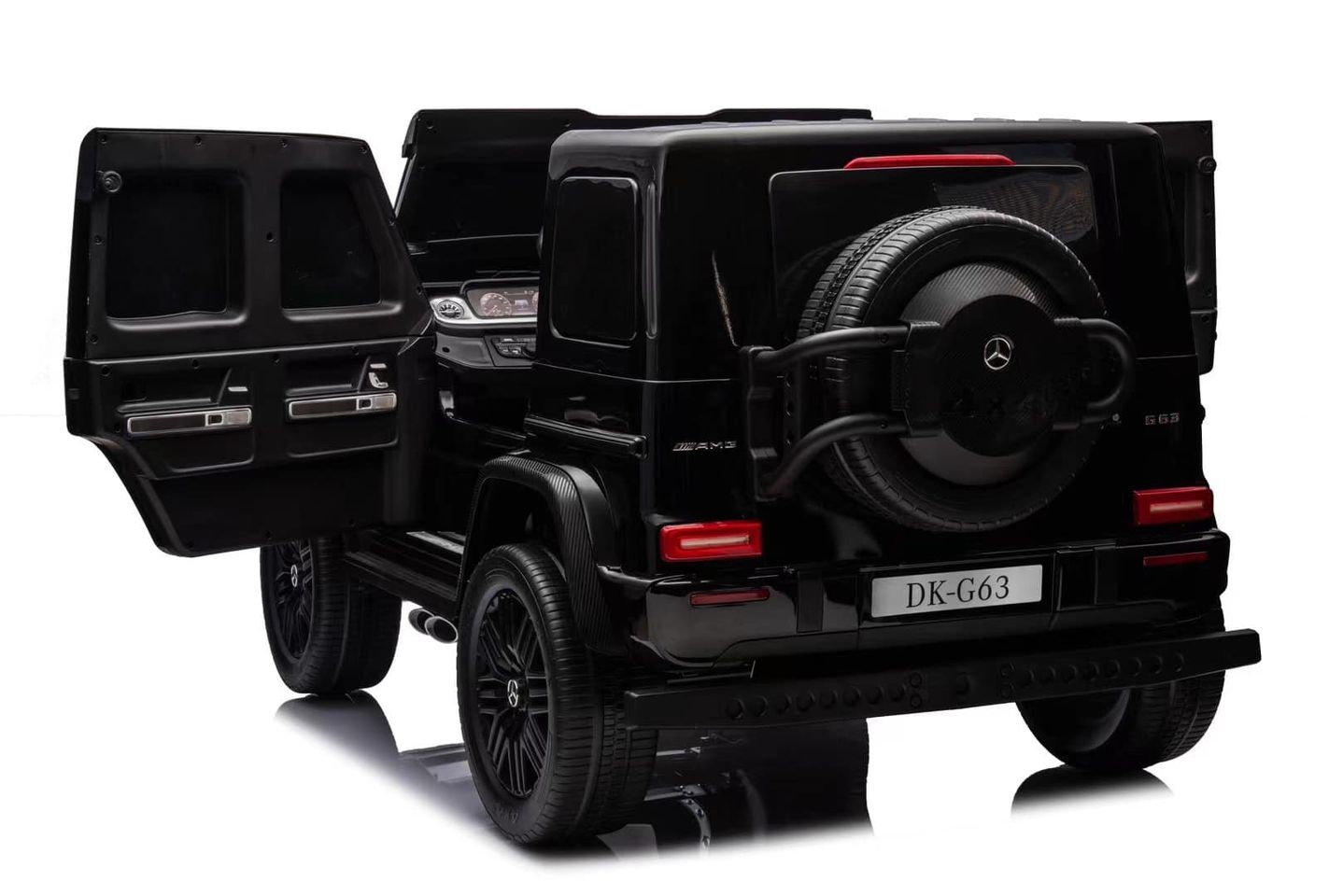 A black Mercedes G63 XXL 24V Kids Ride-On Truck – Platinum Edition with MP4, dual batteries, 4WD, EVA tires, and leather seats stands on a glossy surface. Its open doors reveal the interior seating and a spare tire on the back with a license plate labeled DK-G63 against a plain background.