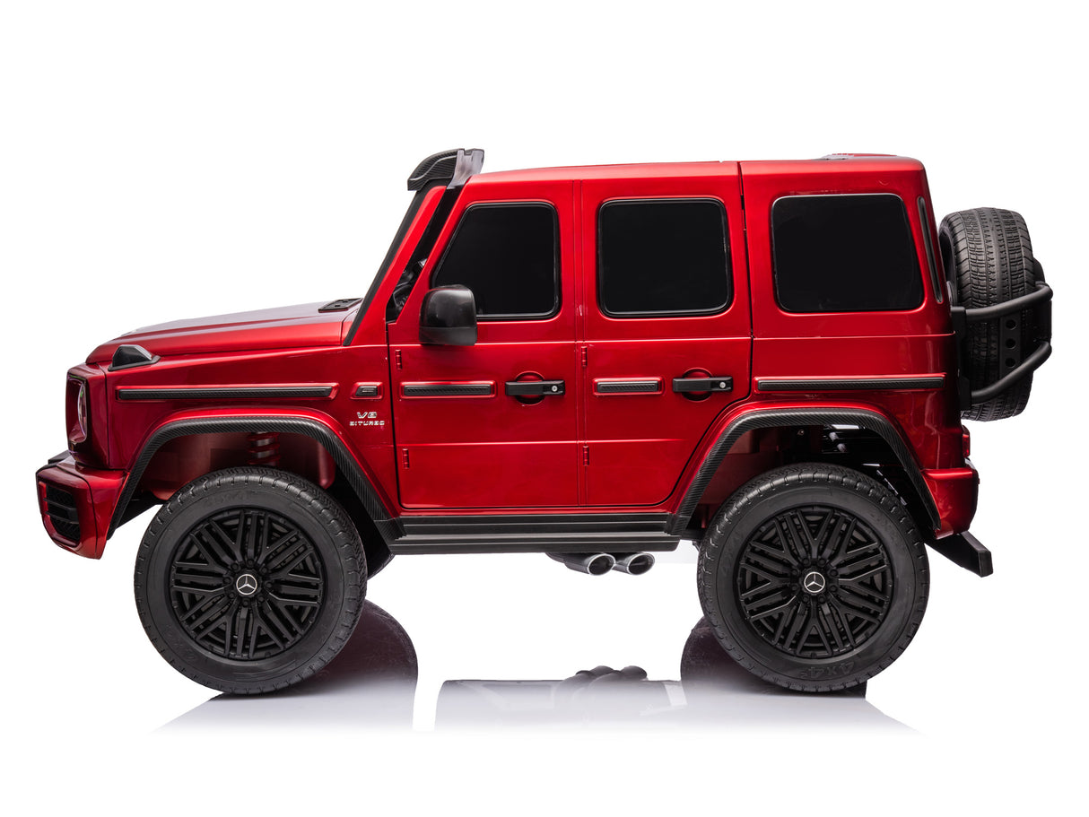 The Red Metallic 2x24V/4WD Platinum XXL Mercedes G63 Ride On Truck features black detailing, large wheels, tinted windows, remote control access, and a rear spare tire—perfect for adventure.
