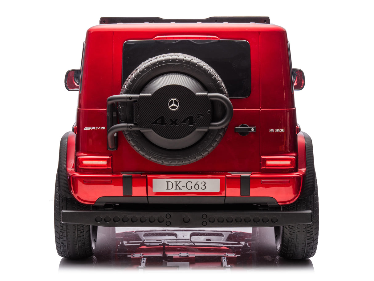 Rear view of a metallic red Mercedes G63 Ride-On Truck with a visible spare tire, license plate DK-G63, and AMG and 4x4² logos. This Red Metallic 2x24V/4WD Platinum XXL model features remote control, MP4, EVA wheels, and leather seats against a white background.