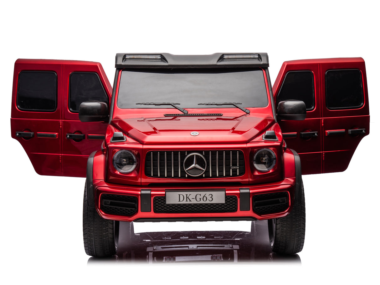 The Red Metallic 2x24V/4WD Platinum XXL Mercedes G63 Ride-On Truck features open doors, a glossy finish, DK-G63 license plate, tinted windows, detailed headlights, and remote control. It is styled like a sporty SUV with an emblem front grille.