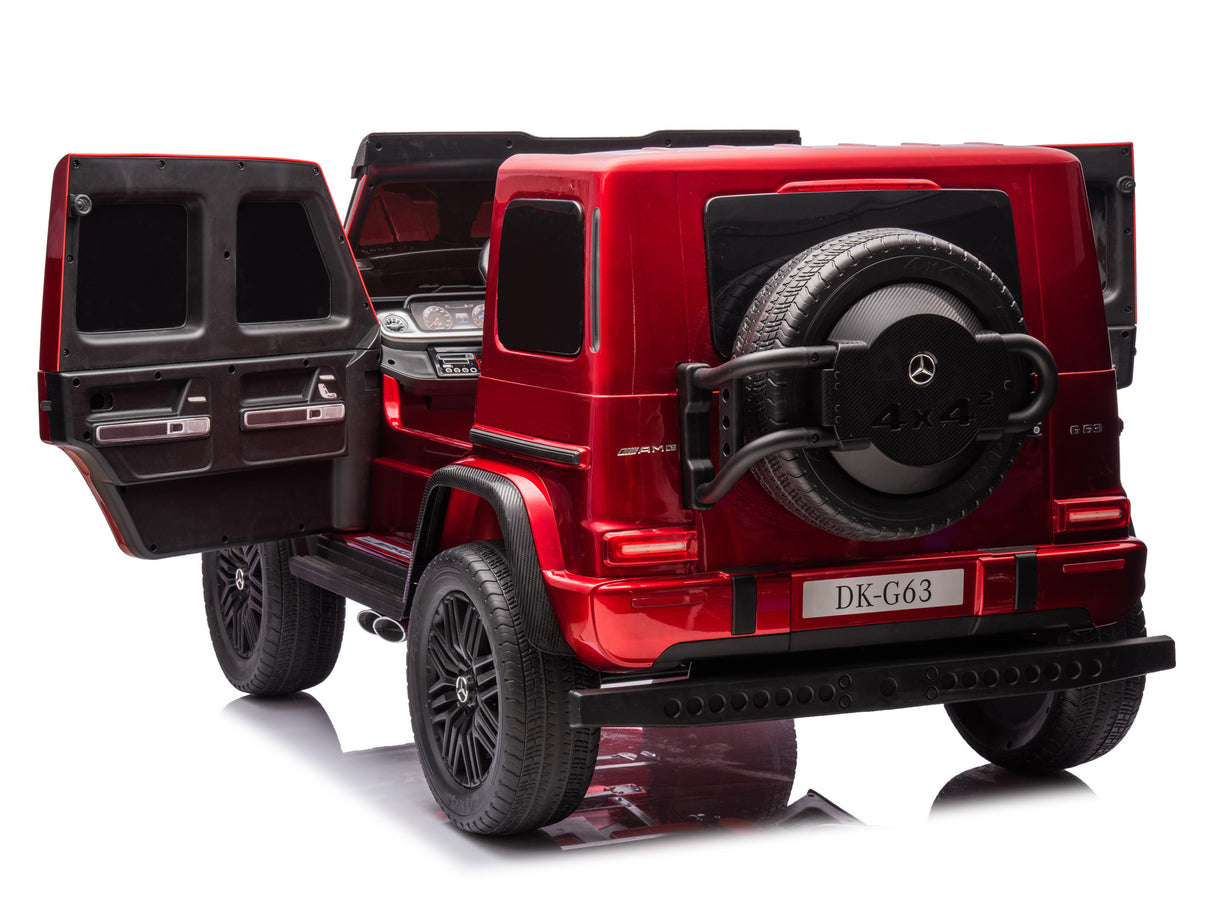 The Red Metallic 2x24V/4WD Platinum XXL Mercedes G63 Ride-On Truck features a luxury SUV style with open rear doors, a visible spare tire, detailed elements like windows and taillights, an DK-G63 plate, and remote control access for an authentic driving experience.