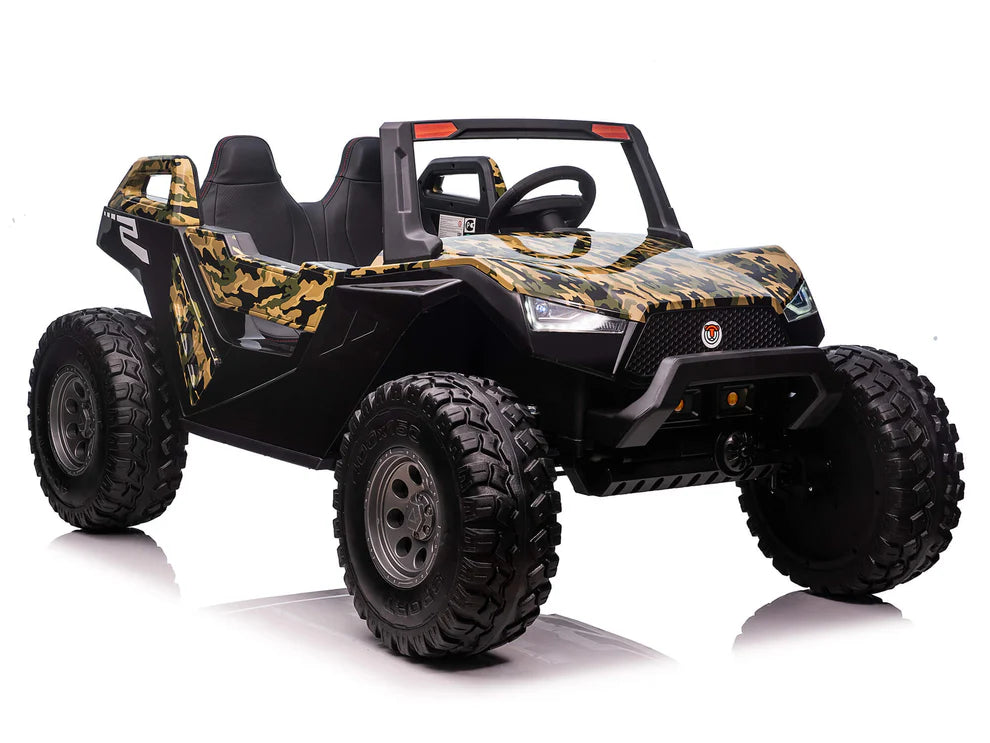 The Camo 24V/4X4 Dune Buggy Ride On UTV features a rugged off-road design with a camouflage finish, large rubber wheels, two seats, and a detailed steering wheel. It includes a parental remote for added safety and is set against a white background.