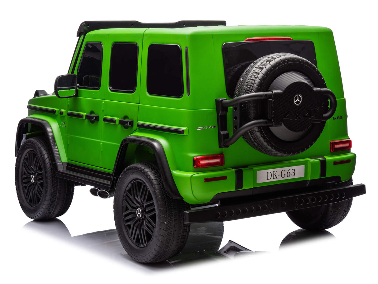 The Green Mercedes G63 XXL Kids Ride-On Truck features black rims, tinted windows, a rear spare tire, a DK-G63 license plate, 24V/4WD power, and remote control. This Platinum Edition includes MP4 functionality, dual batteries, EVA tires, and leather seats on a reflective white surface.