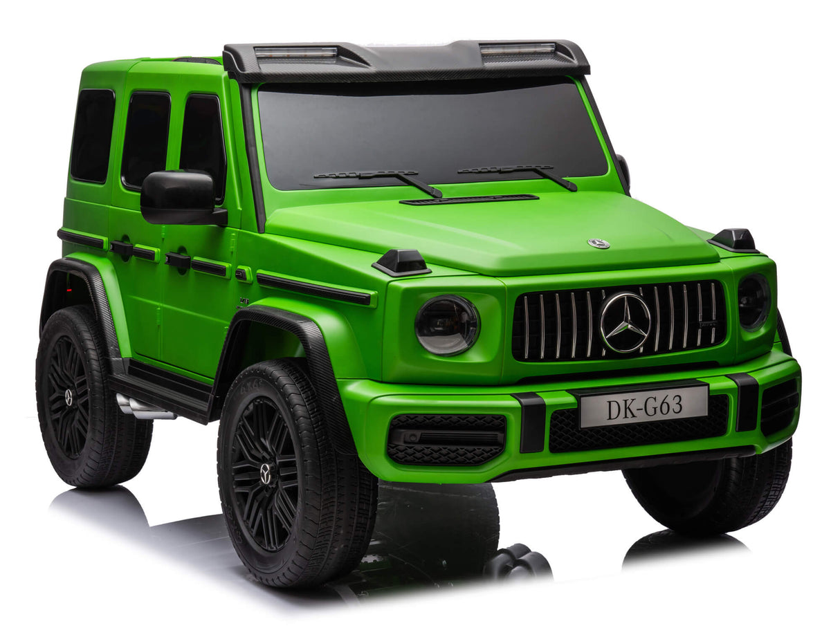 A small, bright green toy car resembling the Green Mercedes G63 XXL Kids Ride-On Truck – Platinum Edition with MP4 features black accents, a detailed grille, EVA tires, leather seats, DK-G63 license plate. Displayed on a reflective surface, this 24V/4WD marvel showcases realistic design elements.