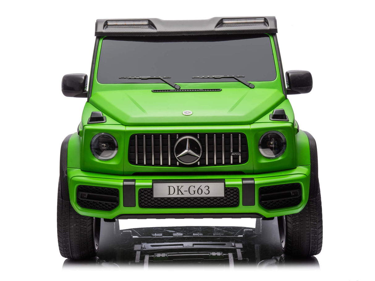 Front view of the Green Mercedes G63 XXL 24V Kids Ride-On Truck on a white background, showcasing its black grille, headlights, and license plate DK-G63. The Platinum Edition offers MP4, dual batteries, 4WD with EVA tires and leather seats for remote-controlled excitement.