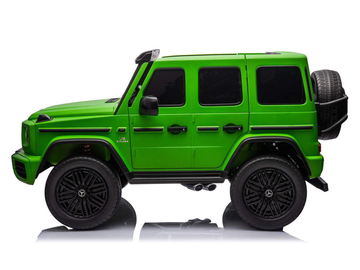 The Green Mercedes G63 XXL 24V Kids Ride-On Truck – Platinum Edition, features black windows, large black wheels, a spare rear-mounted tire, and offers remote control. Displayed in side profile on white background with MP4, dual batteries, 4WD power, EVA tires, and leather seats.
