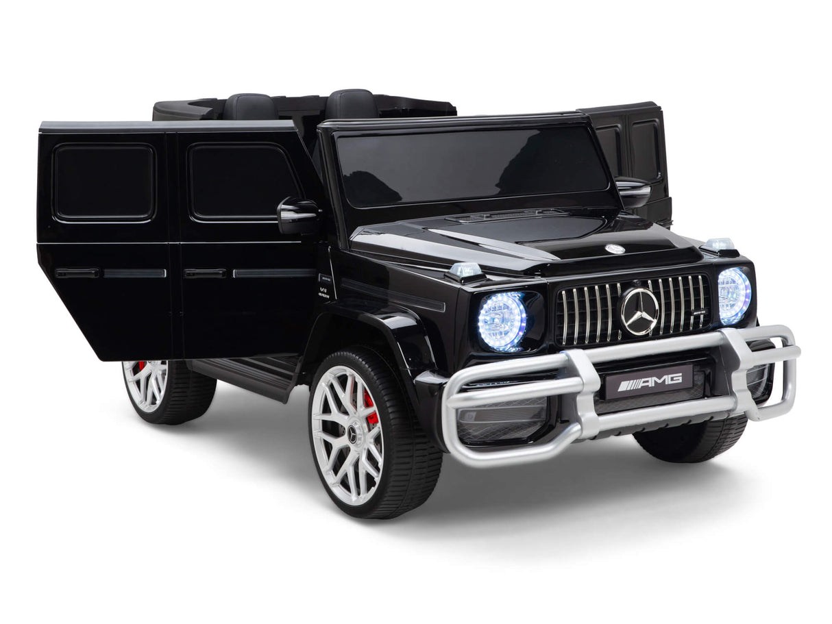 Experience the luxurious Black 24V Mercedes Benz G63 Kids Ride On Car, featuring open doors, LED headlights, a detailed silver grille and bumper, red brake calipers, AMG badge, sleek design with 4x4 power, and RC mode for the ultimate blend of style and performance.