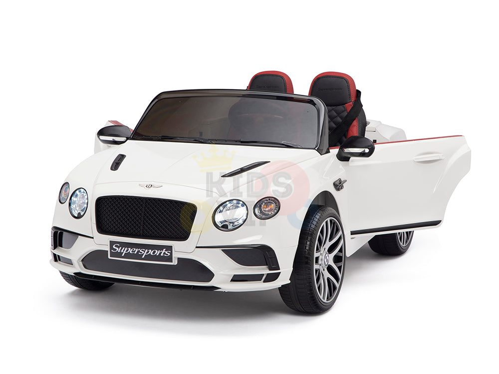 The White 12V Bentley GTC Kids Licensed Ride-On Car is a luxury convertible with black and red leather seats, an intricately detailed front grille, and rubber wheels. Dubbed the Supersports, it includes a remote control for an exhilarating two-seater ride.