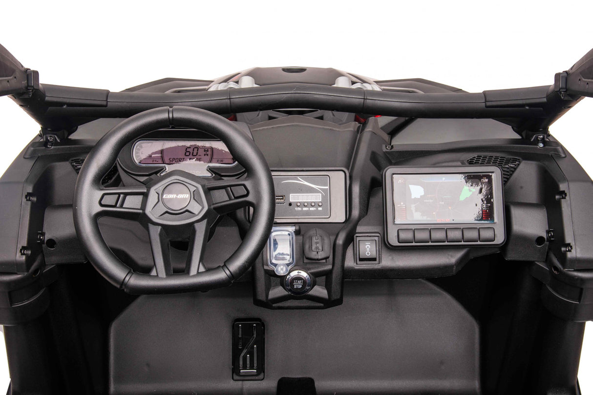Interior view of the Red 2x24V/2WD Official Can-Am Maverick Ride on Buggy, LX Performance: includes a driver’s steering wheel, digital speedometer display, infotainment screen, and multiple controls. This thrilling 2-seater boasts a rugged and modern design.