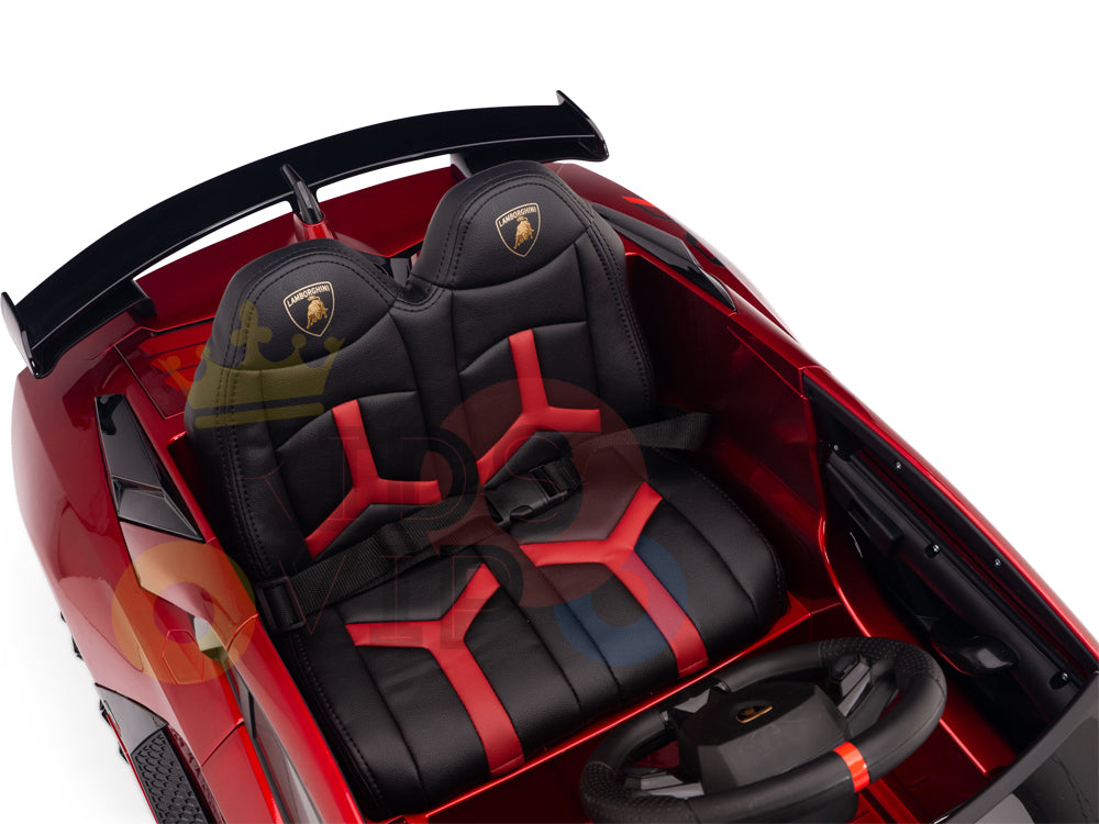 The Burgundy Red 12V Lamborghini SVJ Sport Kids Licensed 1 Seater Ride On Car features black and red bucket seats with a gold emblem, sports car-style dashboard and steering wheel, a black rear spoiler, and thrilling rides powered by a 12V battery with remote control.