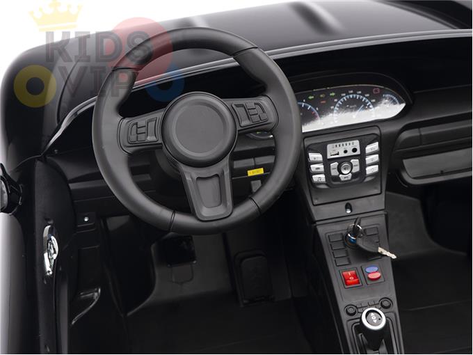 The Black 24V XXL SuperSport Big Kids Ride On Car boasts a realistic interior with a steering wheel, dashboard, speedometer, and control panel complete with buttons and an ignition key. Its detailed craftsmanship includes ECO leather seats that emulate a real cars cockpit.