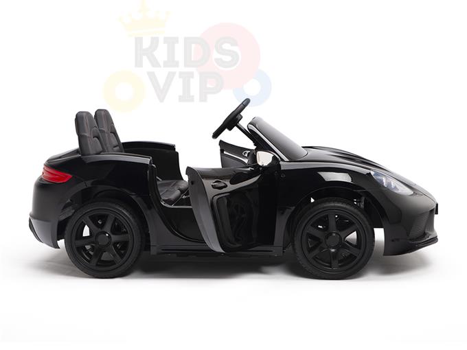 The Black 24V XXL SuperSport Big Kids Ride On Car, equipped with a 180W brushless motor and real tires, features ECO leather seats, two seats, a steering wheel, and an open door. This sleek black toy car is stylishly parked against a plain white background.