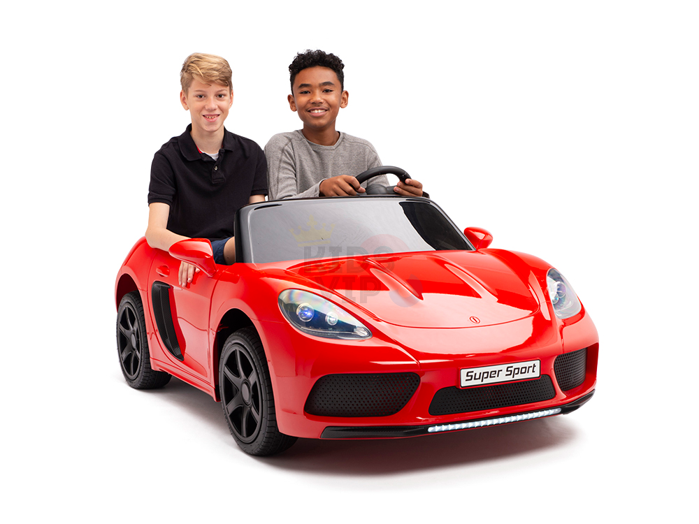 Two boys sit in a red 24V XXL SuperSport Big Kids Ride On Car, styled like a convertible. One steers from the drivers seat while the other beams beside him, both thrilled as they ride with its 180W brushless motor and real tires, perfect for young adventurers.