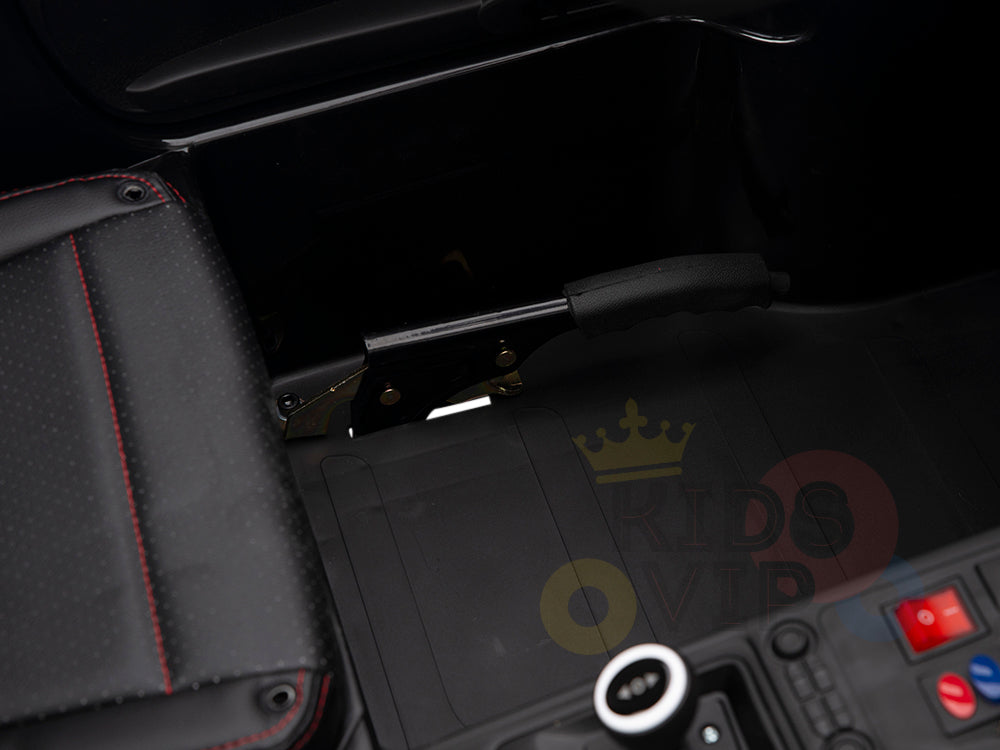 Close-up of the handbrake lever in the Metallic Blue 24V XXL SuperSport Ride On Car with eco leather seats featuring red stitching. The black floor mat complements its sleek design, while control buttons enhance its modern functionality.