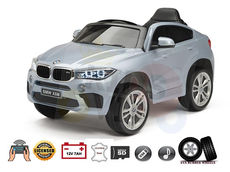 The Silver Limited Licensed BMW X6M 12V Kids Ride-On Car with Remote Control features realistic details including a steering wheel logo, large wheels, leather seat, micro SD capability, and EVA rubber wheels, making it perfect for young adventurers.