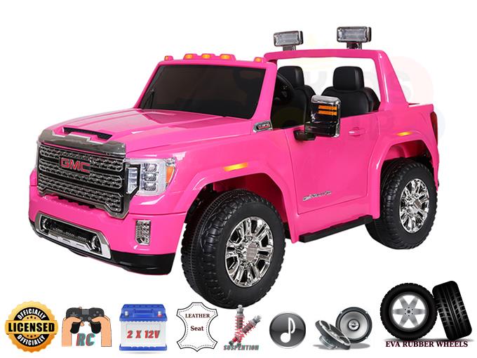 The Pink 2x12V Licensed 4WD GMC Sierra Kids Ride On Car features chrome wheels, an open top, functional headlights, and icons for remote control. It includes dual 12V batteries, a leather seat, suspension system, sound system, and EVA rubber wheels.