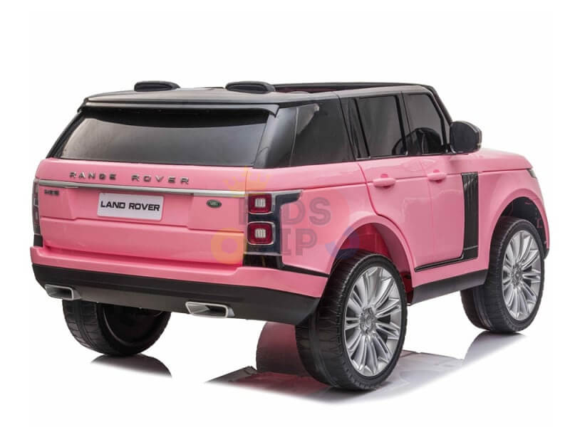 The Pink 24V Official Range Rover Complete MP4 Edition Kids Ride On Car with RC, inspired by a Land Rover, features tinted windows, black accents, large realistic wheels, and detailed design touches like a rear license plate area adorned with the iconic Land Rover logo.