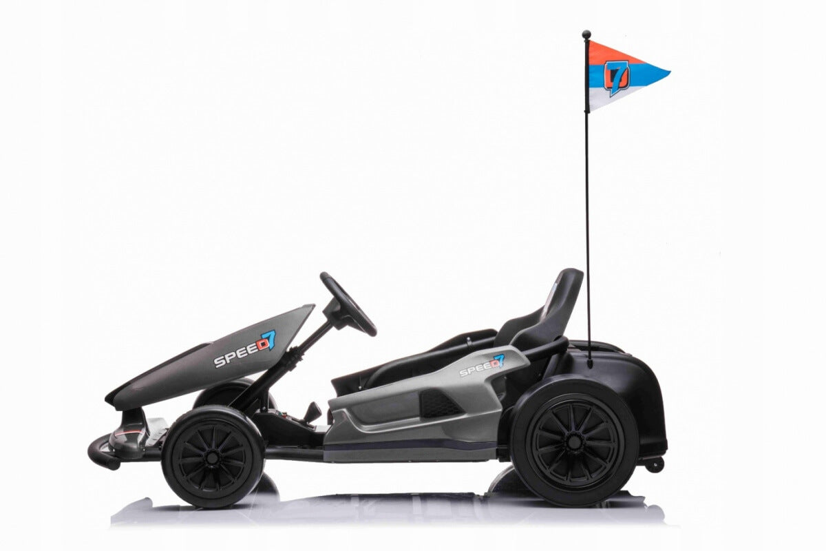 Introducing the Grey Big Kids 24V Ultra-Violent Complete Edition Drifting Go-Kart: a black and gray pedal-powered marvel with sleek branding, compact steering, and a comfy black seat. A vibrant flag flutters as you ride in style—a perfect choice for thrilling drifting adventures!.