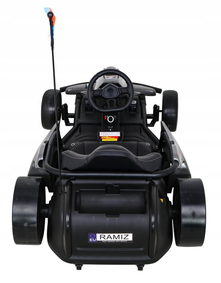 The Grey Big Kids 24V Ultra-Violent Complete Edition Drifting Go-Kart features a slick black design with large wheels, a seat, steering wheel, and rear flag pole. Its compact, sporty look stands out from an above view.
