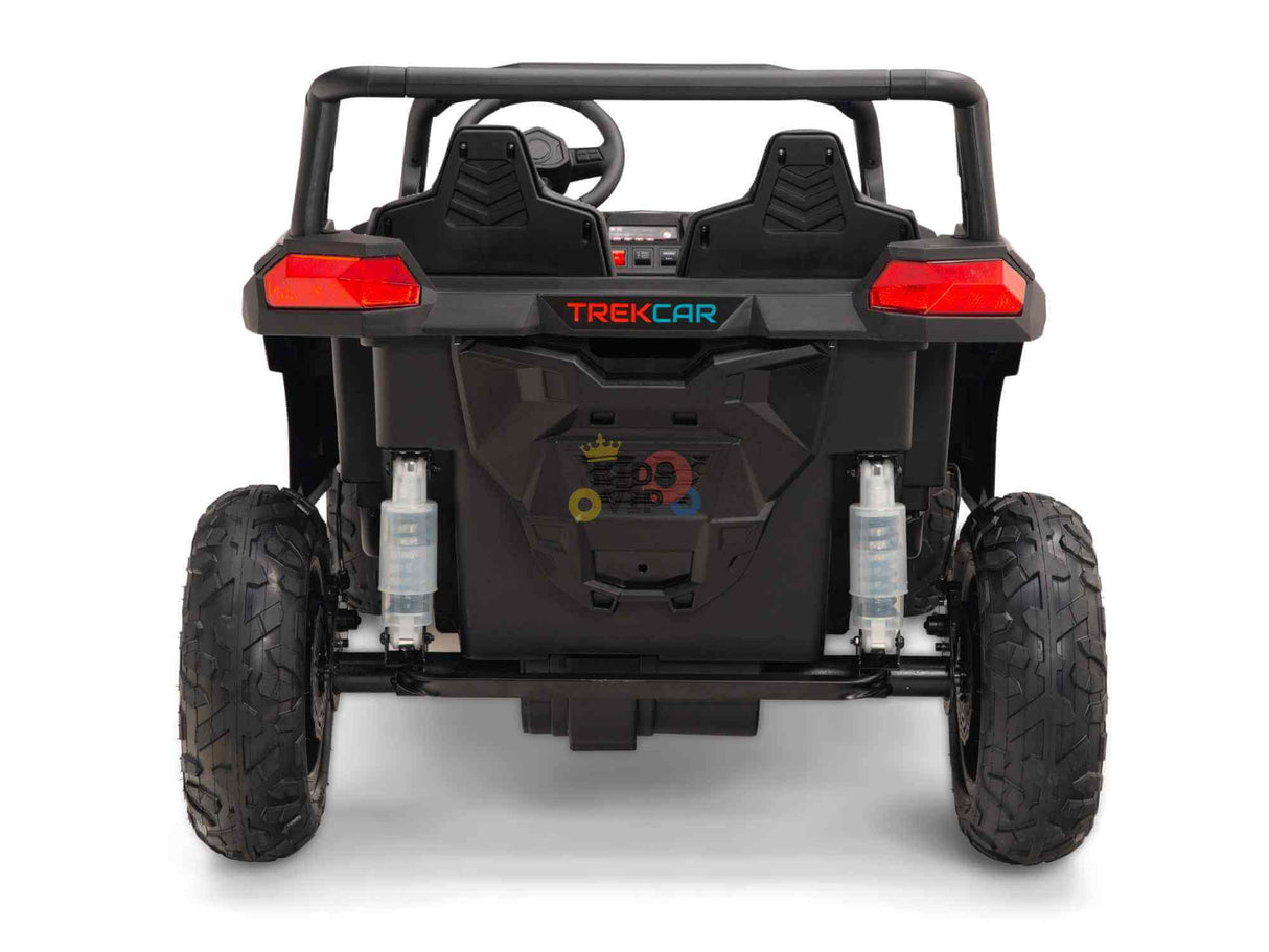 Rear view of the Black 24V/180W XXL Big Kids Blade XR Ride on Buggy with inflatable rubber tires and ECO leather seats. TREKCAR above the rear bumper, dashboard, steering wheel visible, bright red taillights enhance the rugged design.