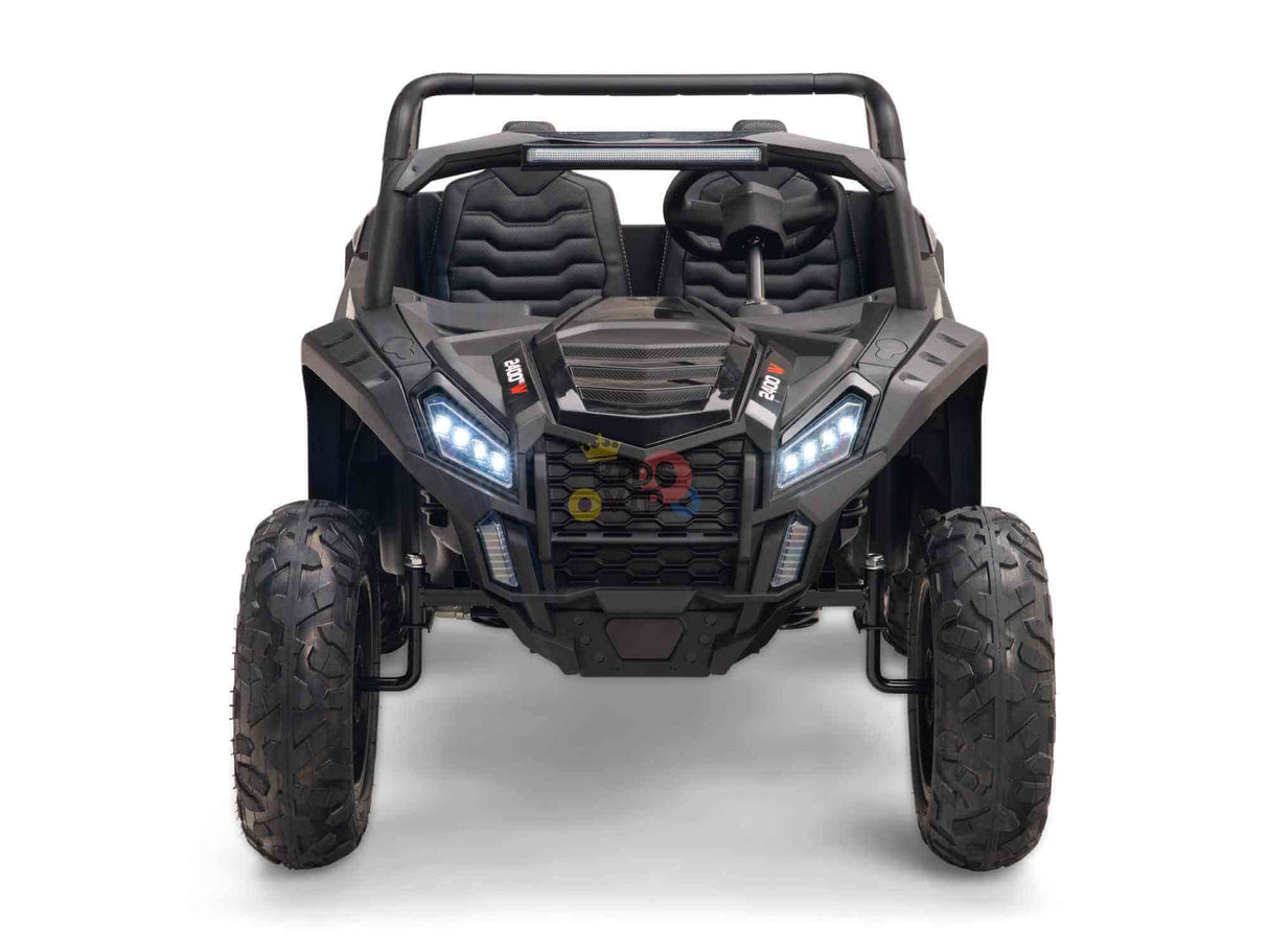 Front view of the Black 24V/180W XXL Big Kids Blade XR Ride on Buggy, featuring inflatable rubber tires and LED-like headlights. Its interior includes ECO leather seats for two, a robust steering wheel, and a roll bar design.