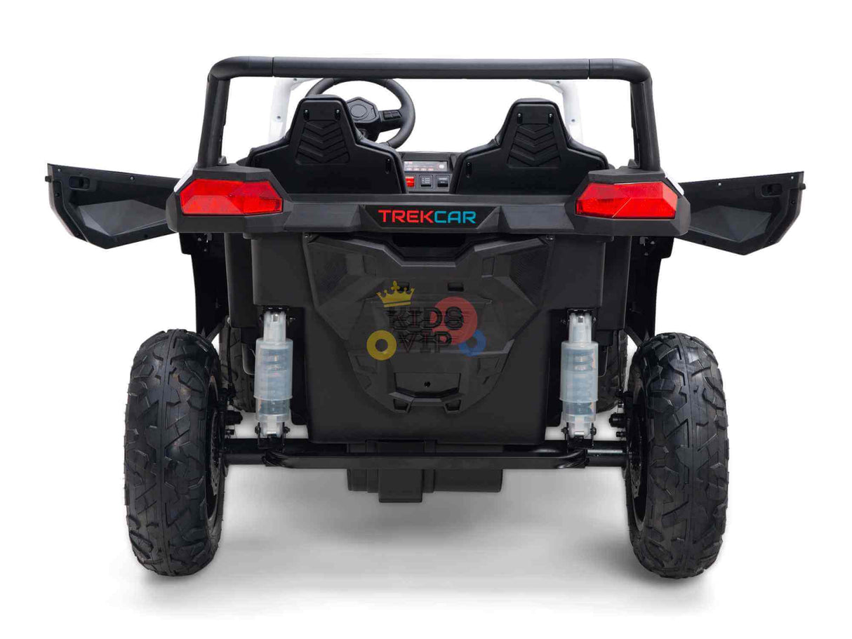 Rear view of the White 24V/180W XXL Big Kids Blade XR Ride on Buggy with TREKCAR in red. It features large inflatable rubber tires, open doors, visible shock absorbers, and a blurred logo with colorful circles and crowns on the back panel.