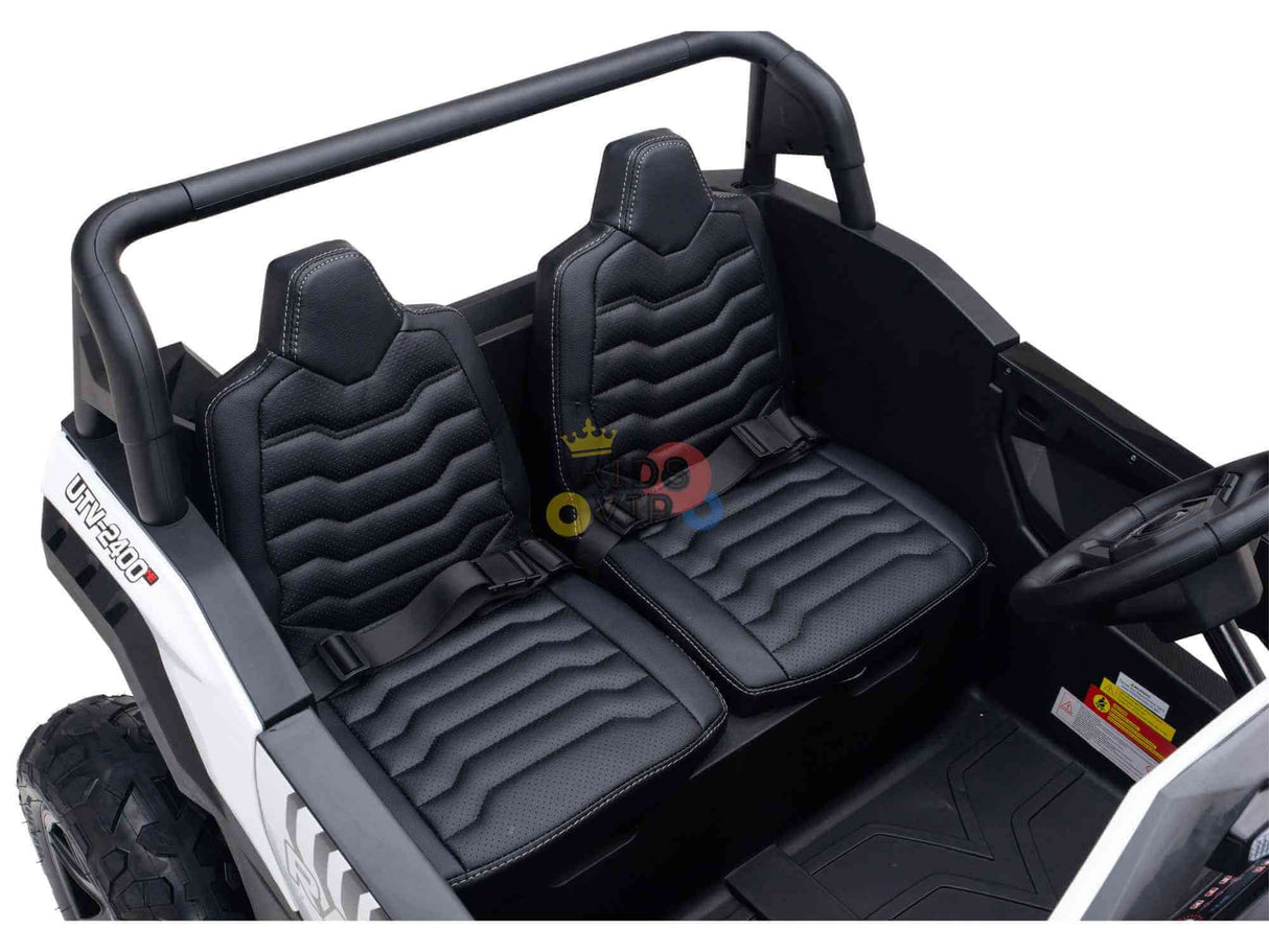 The White 24V/180W XXL Big Kids Blade XR Ride on Buggy features two black leather-look seats with seat belts, a minimal dashboard with a steering wheel, and an off-road vehicle design enhanced by inflatable rubber tires for a stable ride.