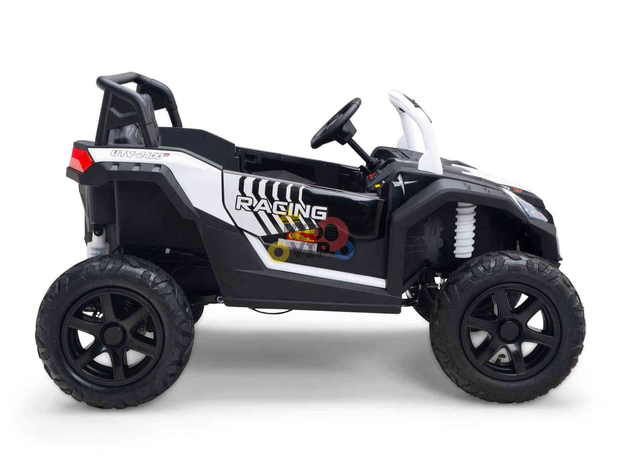 The White 24V/180W XXL Big Kids Blade XR Ride on Buggy, No RC, is a black and white buggy toy with inflatable rubber tires. It has Racing text on the side, includes a steering wheel and open seats, and is designed to mimic an off-road vehicle.