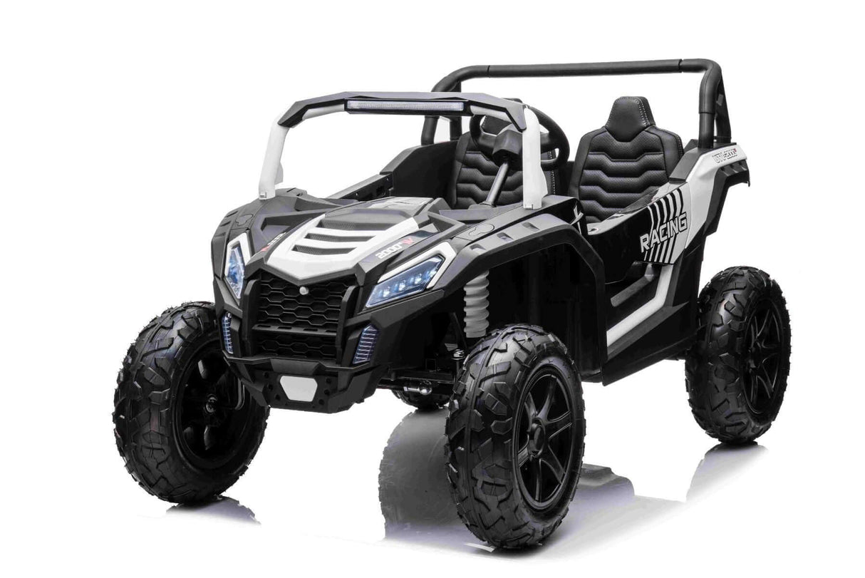 The White 24V/180W XXL Big Kids Blade XR Ride on Buggy is a black and white toy car with large inflatable rubber tires, detailed grille, open sides, two padded seats, and a roll bar. It boasts sporty aesthetics set against a plain white background.