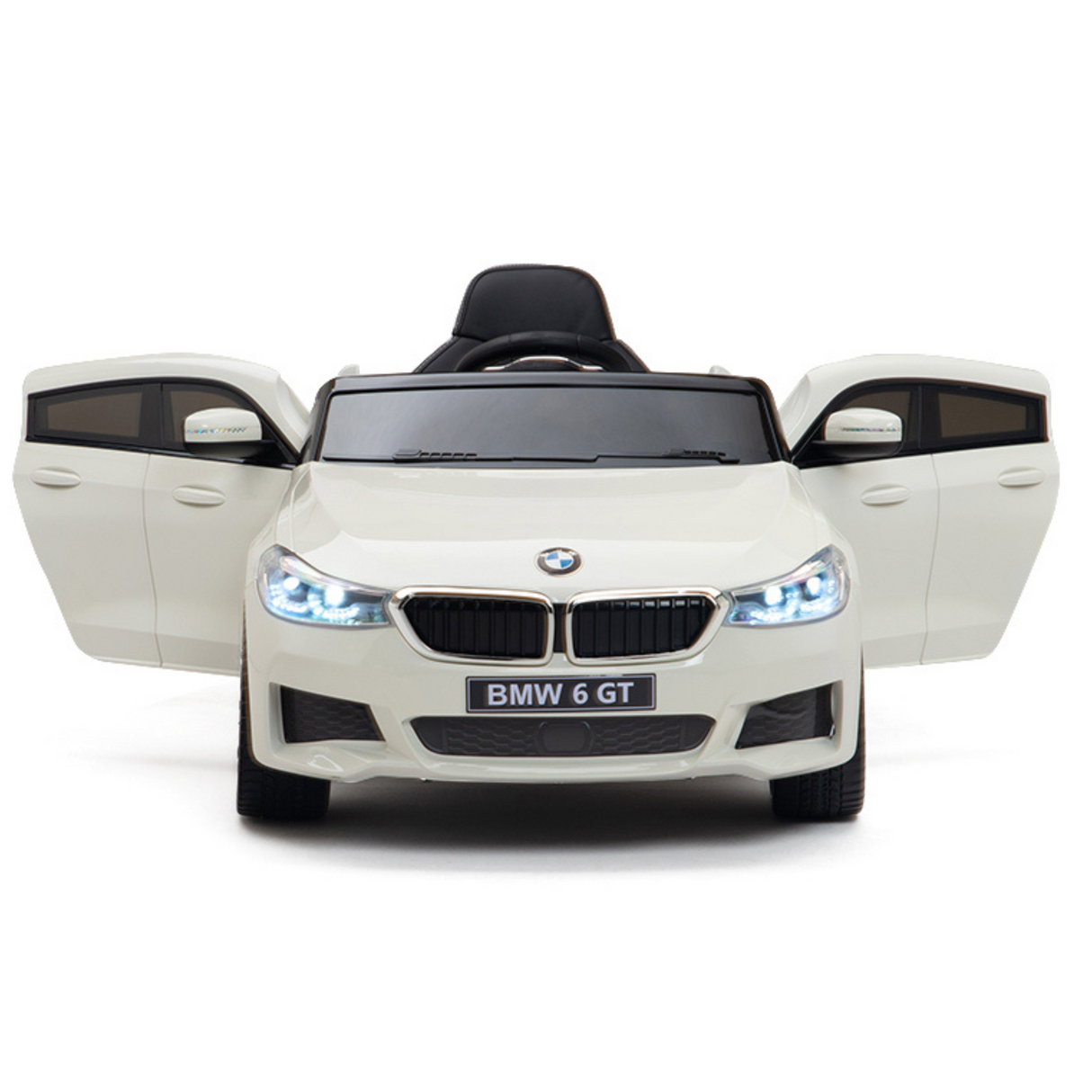 The White 12V BMW GT Kids Licensed 1 Seater Ride On Car, featuring rubber wheels and a remote, has openable doors that reveal black details on the grille, mirrors, and seating. With working headlights, it captures the charm of a BMW 6 GT from its front view.