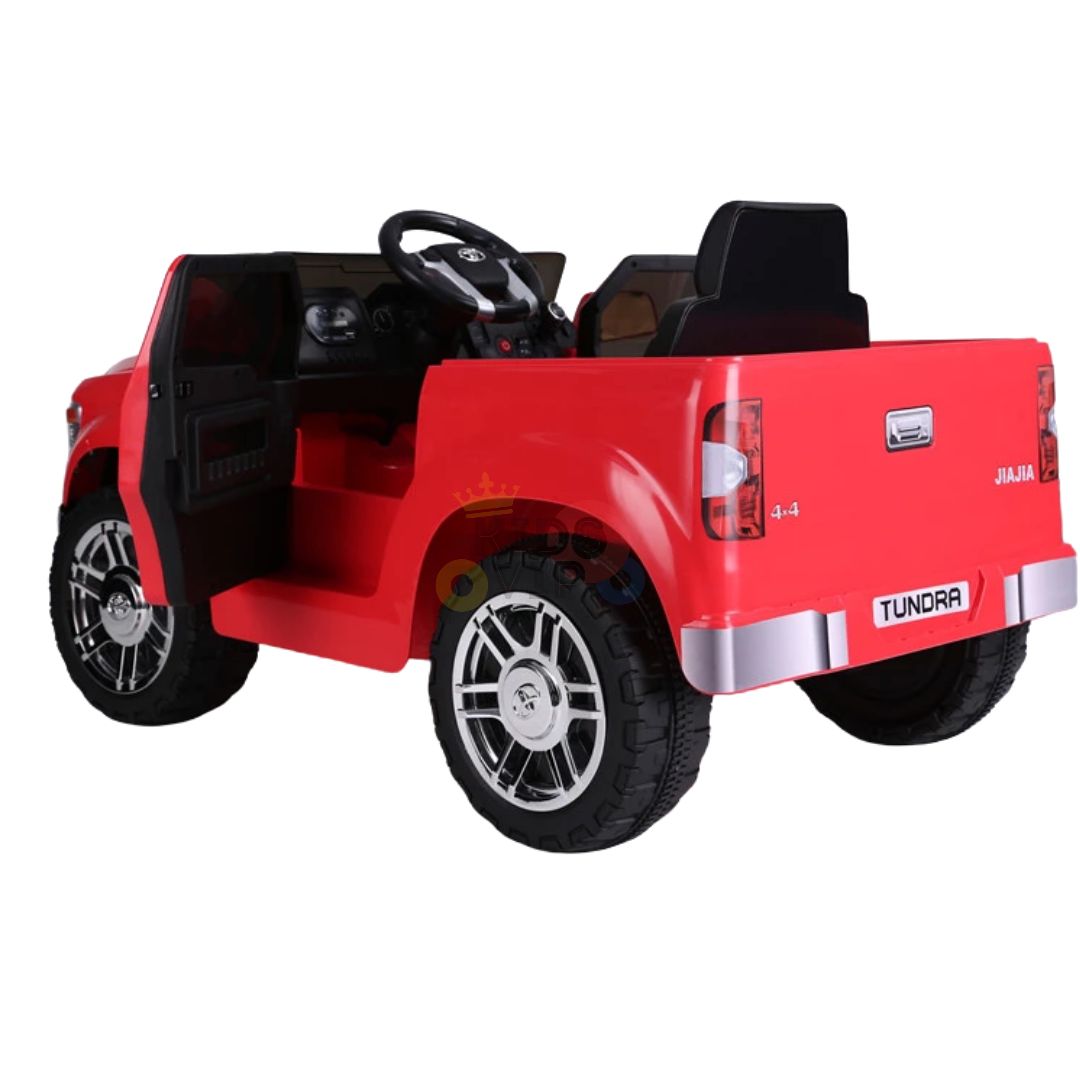 This Red 12V Licensed Upgraded Toyota Tundra Kids Ride On Truck features black seats, large black and silver wheels, an open top, steering wheel, doors with 4x4 and TUNDRA labels, and includes a parental remote control for safety.