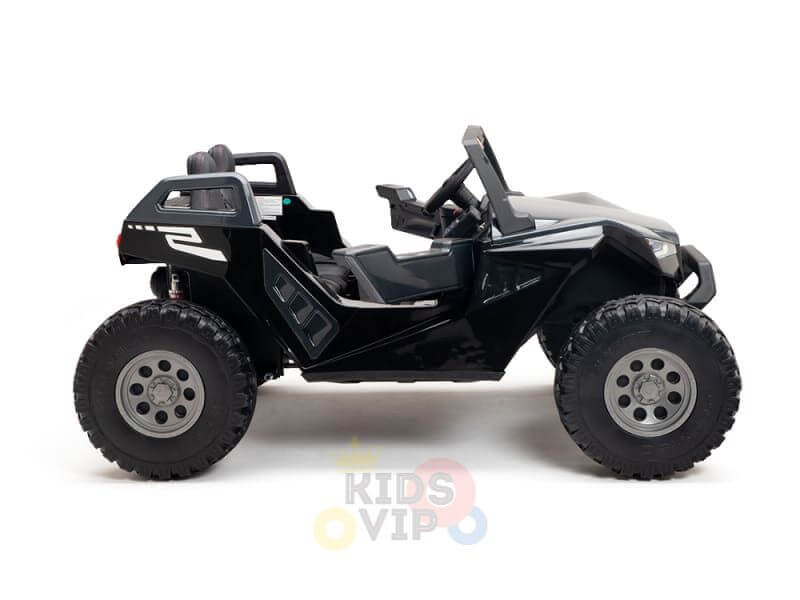 The Kids XXL Black 24V/4X4 Dune Buggy Ride-On UTV features a sleek, angular design with large rubber wheels and an open top. A white stripe detail runs along the side, making it perfect for outdoor play with its blend of style and adventure.
