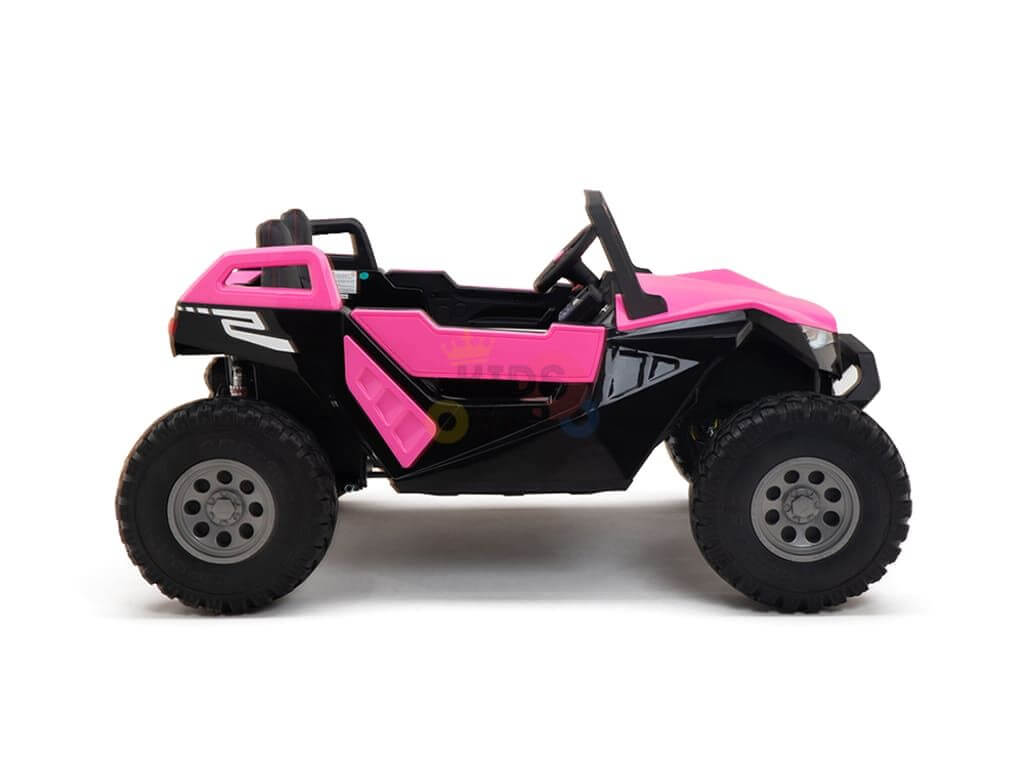 A small black off-road vehicle with bright pink detailing for kids, the Pink 24V/4X4 Dune Buggy Ride On UTV features large rubber wheels and a simple open-frame design. It is shown in profile against a plain white background.