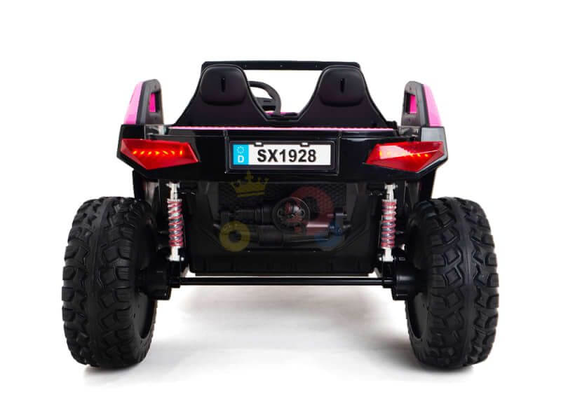 The Pink 24V/4X4 Dune Buggy Ride On UTV is styled as a toy electric car with large rubber wheels and a license plate reading SX1928. Its red rear lights and pink accents stand out against the white background, making this Kids XXL Edition unique.