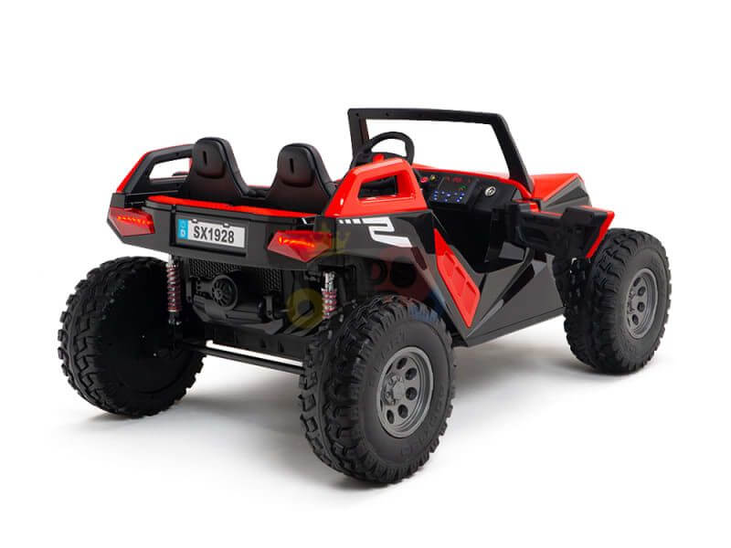 The Red 24V/4X4 Dune Buggy Ride On UTV features large tires, a steering wheel, and two-seat design with visible rear suspension springs. It includes a small SX1928 license plate and comes with rubber wheels and parental remote control.