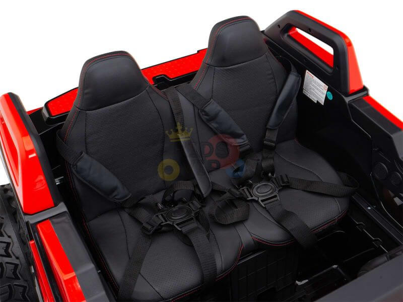 Interior of the Red 24V/4X4 Dune Buggy Ride On UTV features two cushioned black seats with safety harnesses in a red and black sporty frame. It includes rubber wheels and a Parental Remote Control for added safety.