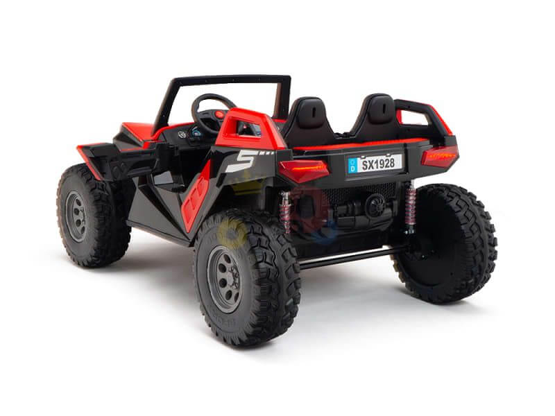 The Red 24V/4X4 Dune Buggy Ride On UTV is a toy car with an off-road design, featuring a black and red color scheme, four rugged tires, two seats, and SX1928 on the license plate. The Kids XXL Edition includes a parental remote control for safety.